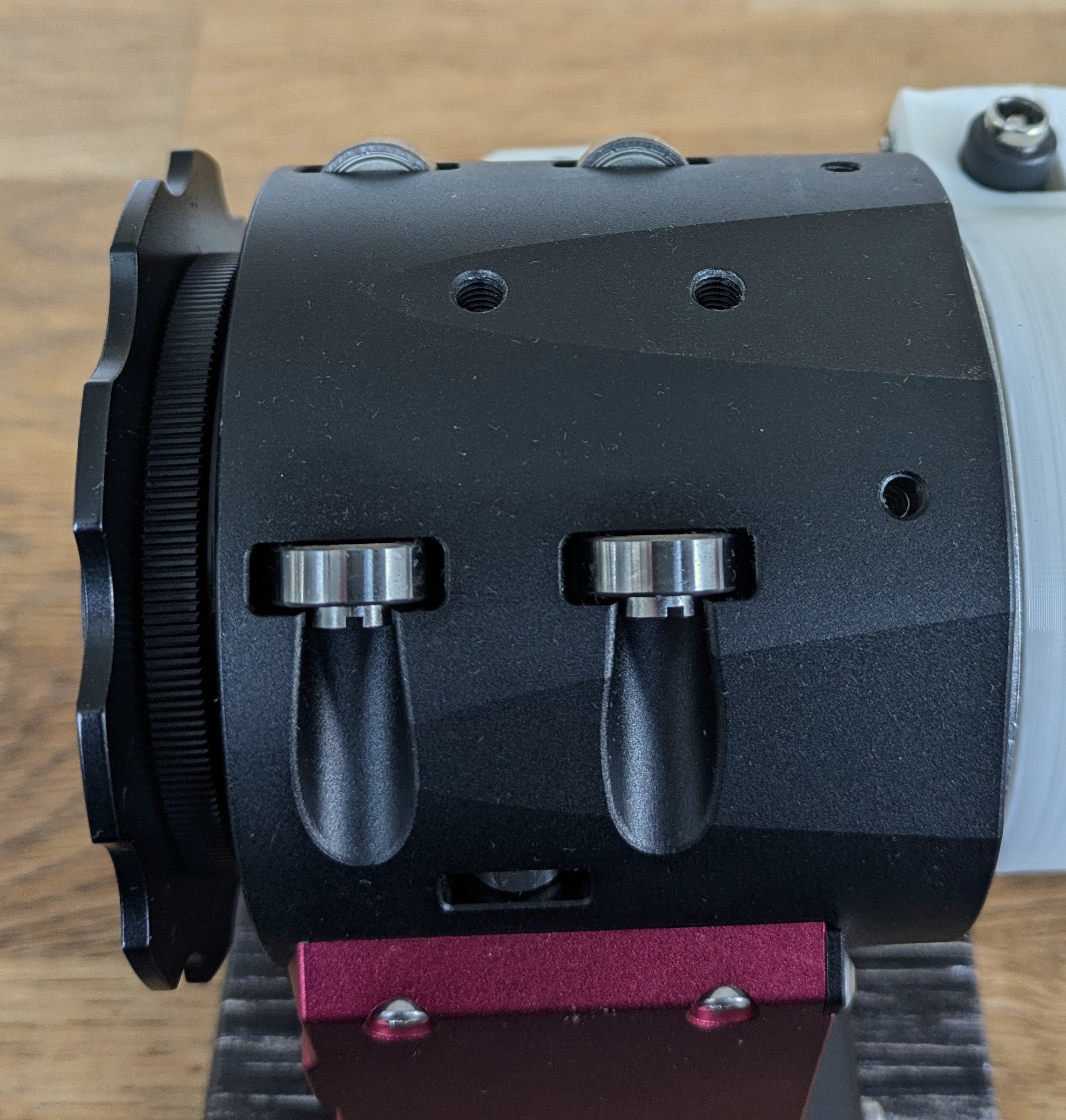 Fixation holes in telescope robotic focuser housing.